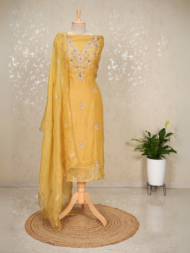 Yellow crush tissue suit with hand embroidery on neck sleeves and all over shirt and dupatta