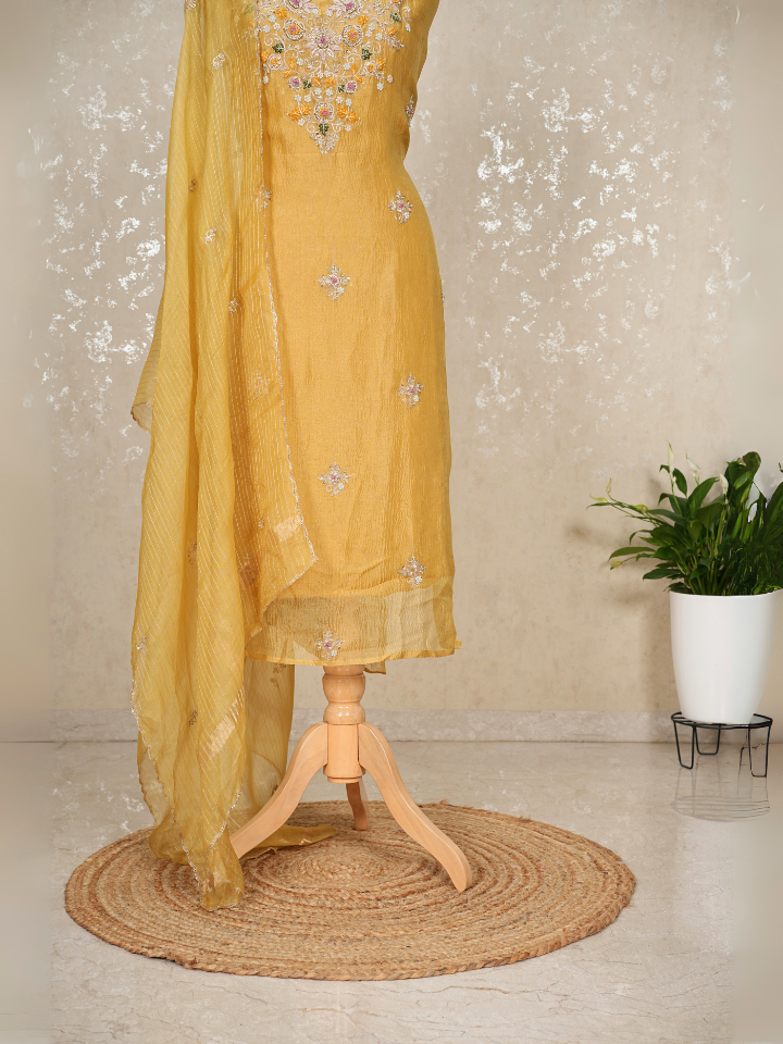 Yellow crush tissue suit with hand embroidery on neck sleeves and all over shirt and dupatta