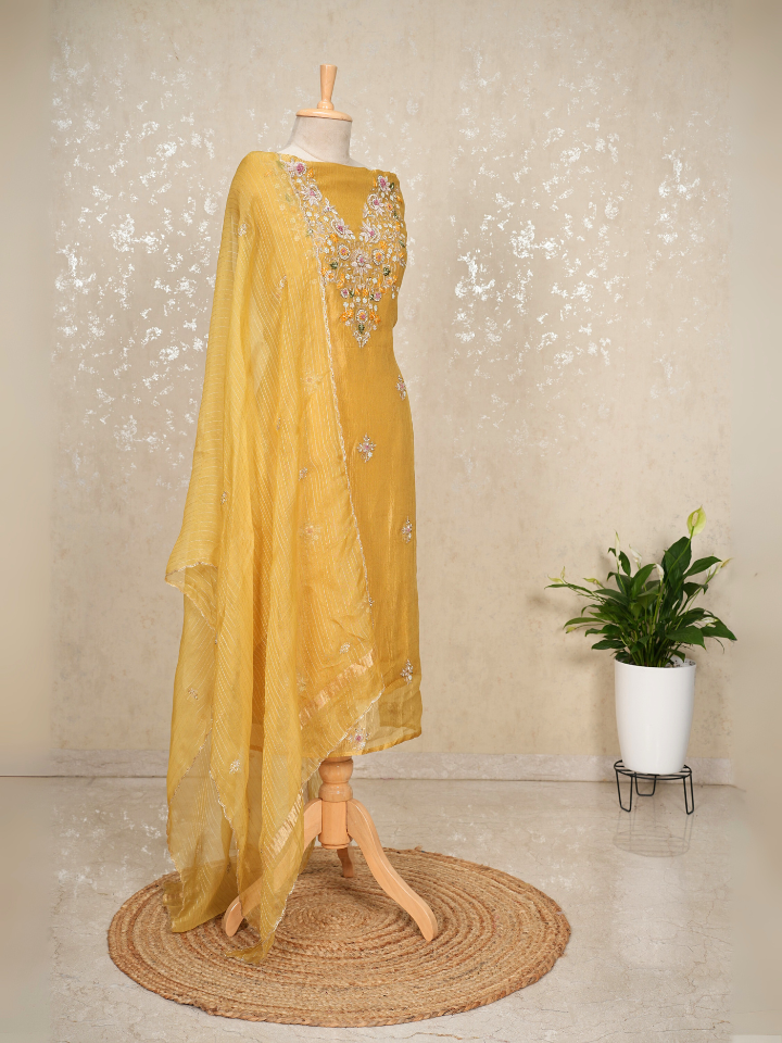 Yellow crush tissue suit with hand embroidery on neck sleeves and all over shirt and dupatta